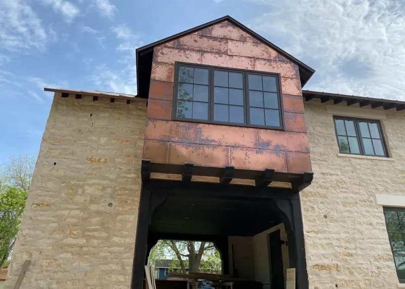 Copper metal panel facade on a stone building for Skylight Installation in Berwyn