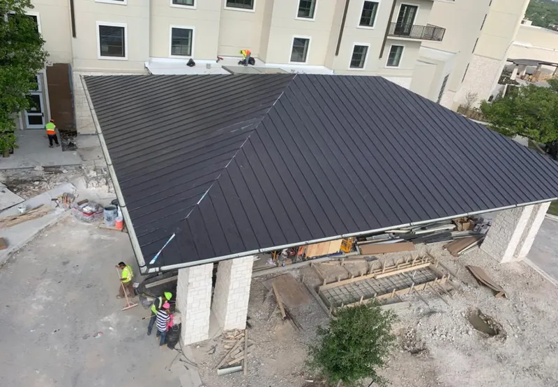 Metal roofing installation team working on a commercial building in Berwyn